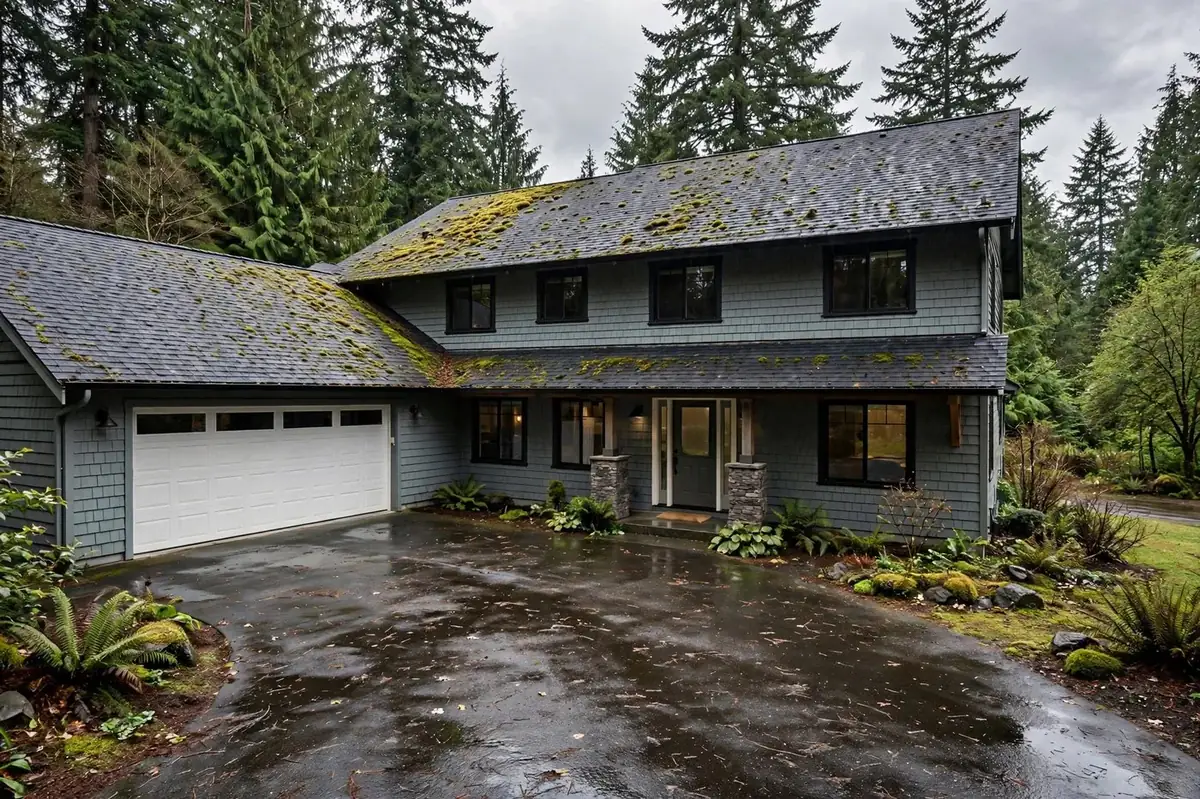 Pacific Northwest home with moss growing on its shingle roof